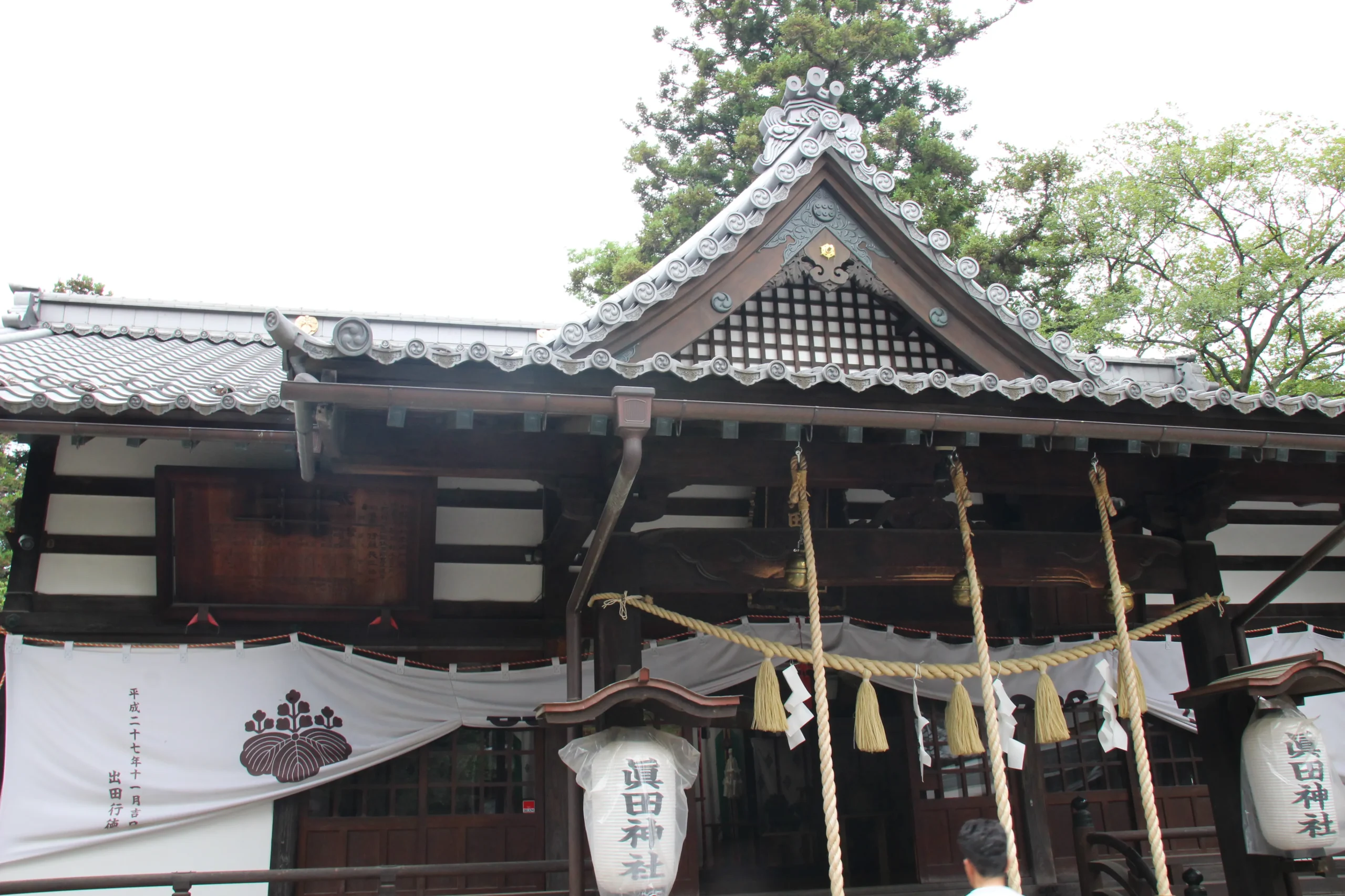 六文銭が白抜きの神前幕が吊るされた眞田神社拝殿の正面クローズアップ