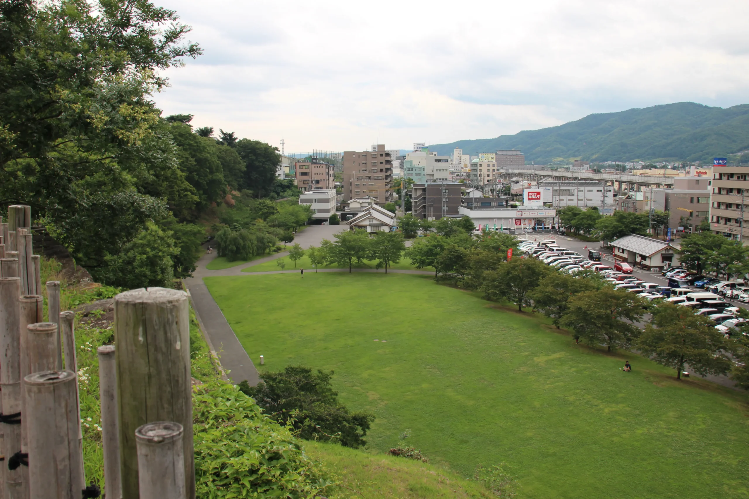 本丸西櫓の展望地から見下ろす尼ヶ淵の広い芝生広場と上田市街のパノラマビュー