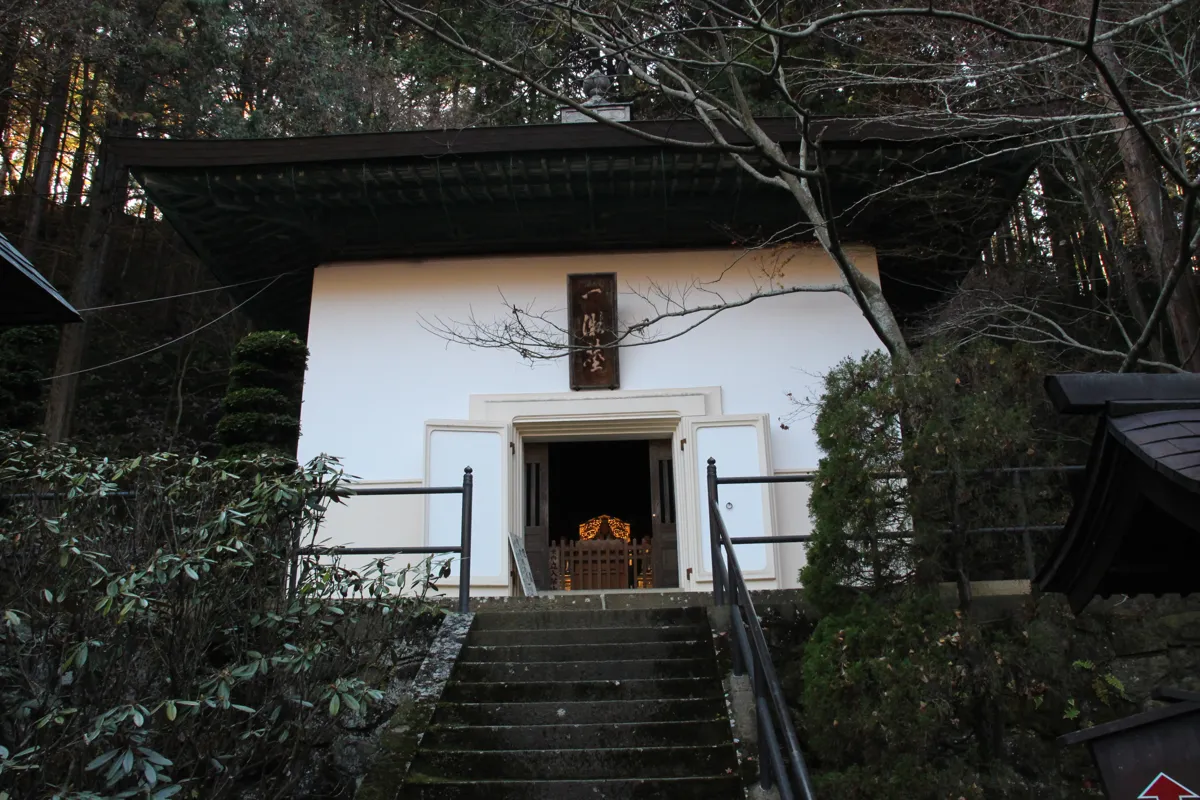 石段の先に佇む白壁と黒屋根の歴史ある伝法堂の外観
