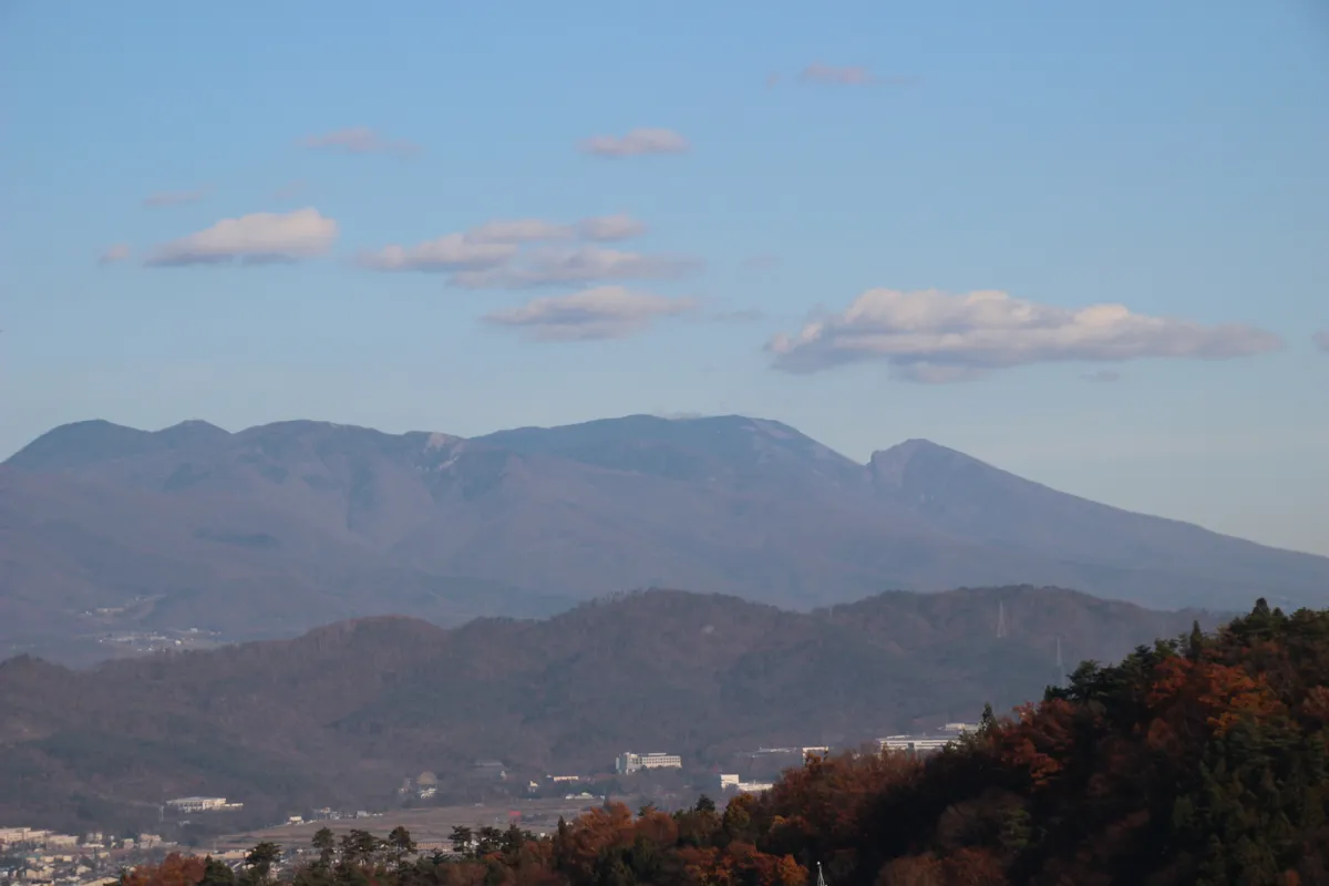展望台からクローズアップした、青空のもとに連なる穏やかな信州の山々の稜線